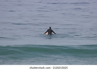 Lone Surfer At The Beach