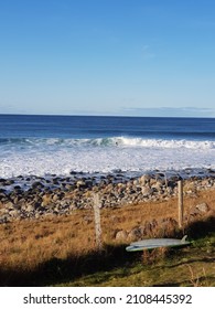 A Lone Surfer In Lofoten Norway