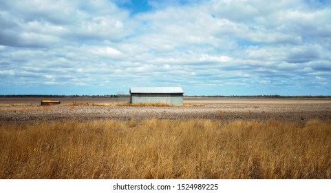 A Lone Tin Shed Standing In A Dry Brown Australian Farm Paddock Suffering From A Lack Of Rainfall