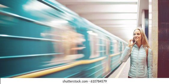 Lone Woman Watching Subway . Speed Electric Train On A Platform In Metro. Girl Talking On The Phone In The Underground