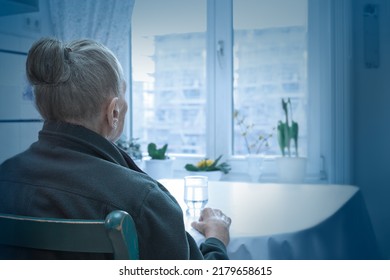 Loneliness Concept, Old-age Depression: Lonely Old Woman Looking Out Of The Window, Blue Filter Effect.