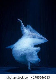 Loneliness. Young Graceful Beautiful Woman, Balerina In White Wedding Dress In Art Performance Isolated On Dark Background In Neon Light. Concept Of Love, Relationship, Beauty, Art And Theater.