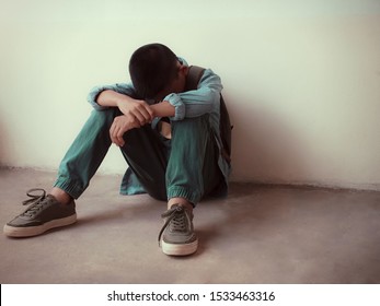 Lonely asian boy student sitting and cry at school. Concept sad child depressed with bullying. 