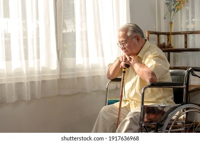 Lonely Asian Senior man was sick and sitting on wheelchair. Retirement age lifestyle and stay at home alone. - Powered by Shutterstock