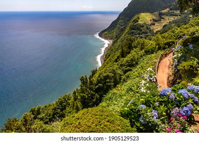 Lonely beautiful viewpoint overlooking the sea and the lush nature of the Azores