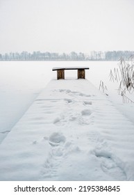 Lonely bench by the lake Gieladzkie Sorkwity in winter. Warmian-Masurian Voivodeship. - Shutterstock ID 2195384845