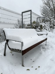 Lonely Bench Under Snow In The Park In Prague.