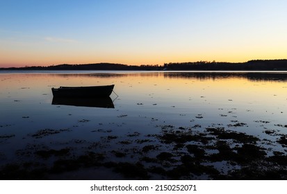 Lonely Boat In Roskilde Fjord Of Denmark During Sunset