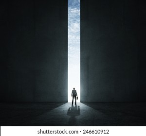 Lonely businessman standing in front of the huge gate - Powered by Shutterstock