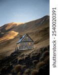 Lonely cabin in the middle of a mountain in a autumn landscape, in the Pyrénées, France