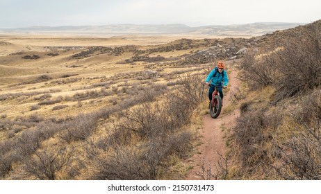 Lonely Cyclist Riding Fat Mountain Bike On A Single Track Trail In Northern Colorado Grassland, Early Spring Scenery In Soapstone Prairie Natural Area Near Fort Collins