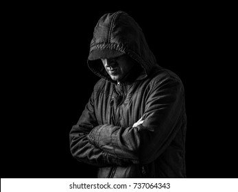 Lonely, Depressed And Fragile Man Hiding Face, Arms Crossed And Standing In The Darkness. Low Key, Black Background. Concept For Loneliness, Depression, Sadness And Mental Health Issues