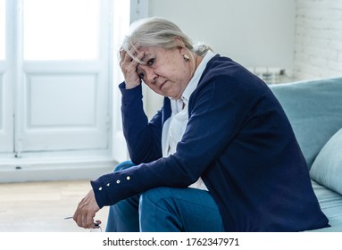 Lonely depressed senior old widow woman crying on couch in isolation at home, feeling sad and worried missing husband and family in COVID-19 Outbreak, lockdown, social distancing and Mental health. - Powered by Shutterstock