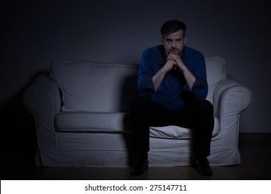 Lonely despair man sitting in dark room
