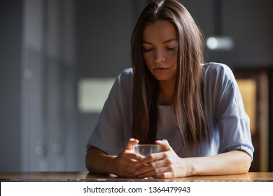 Lonely drunk woman sitting on bar counter feels depressed spends time with strong alcoholic beverages holds glass drinking booze having dependence, addiction. Concept of alcoholism and social problems - Powered by Shutterstock