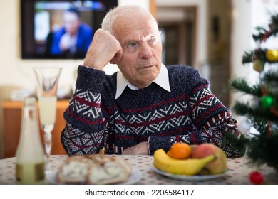 Lonely Elderly Man Drinking Alcohol At Christmas