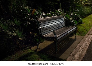 Lonely, Empty Park Bench At Night.