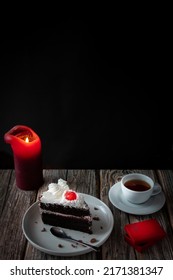 Lonely Evening Chocolate Cake With Tea By Candlelight. Mysterious Gift Box. Cozy Warm Mood. Congratulation Or Sympathy Image Concept. Copy Space.