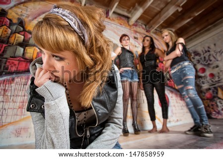 Lonely female being teased by group of people