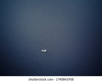 Lonely fisherman in the middle of the lake - Powered by Shutterstock