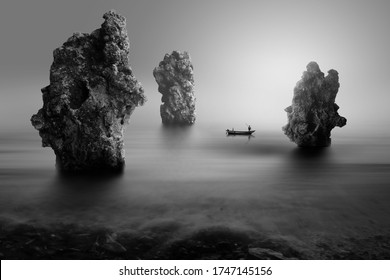 Lonely Fisherman On The Stone Beach, Black And White Photography