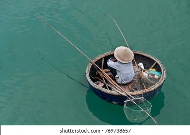A lonely fisherman used only crude fishing gear was waiting patiently inside his round bamboo boat along the calm estuary at Danang, Vietnam. 