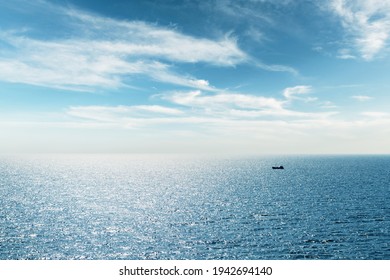 Lonely Fishing Ship Trawler Boat On Ocean Water. Calm Clear Sea Sunny Weather. Beautiful Horizon Of Seascape