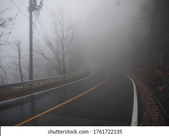 Lonely Foggy road, low visibility, driving by Nikko wet highway on rainy autumn morning, japan 