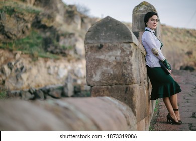 A Lonely Girl Leaning On Wall On Old Bridge