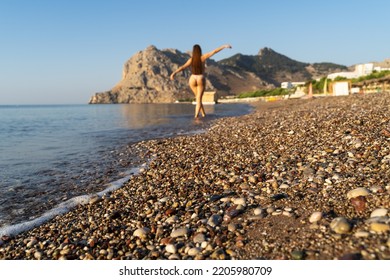 Lonely Girl Walking Along The Sea Along The Beach