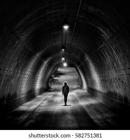 Lonely Girl Walking In A Night Tunnel