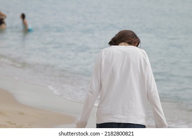 Lonely Girl Walking On The Beach