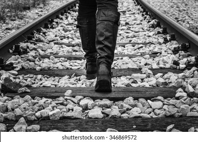 Lonely girl walking on rails - Powered by Shutterstock