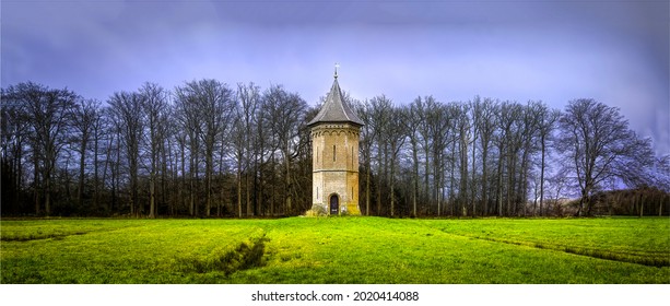 A lonely high tower of ruins in a field