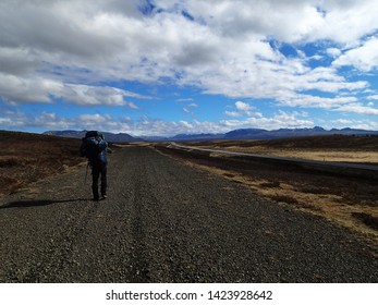 Lonely Hiker On The Road Near þingvallavatn