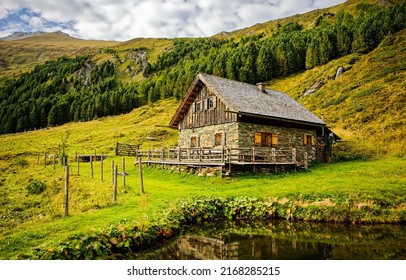 A lonely hut in the mountains. Hut in mountains. Stone hut on hill