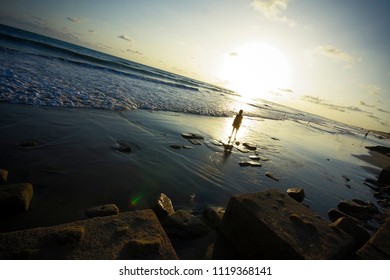 A lonely kid in an empty beach
