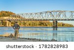 Lonely male figure at the old boat ramp on Missouri River at Taylor