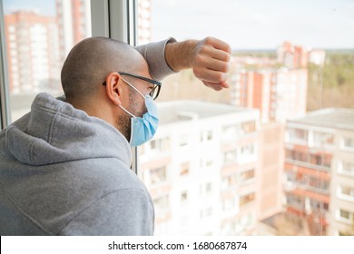 Lonely man in medical mask looking through the window. Isolation at home for self quarantine. Concept home quarantine, prevention COVID-19. Coronavirus outbreak situation - Shutterstock ID 1680687874