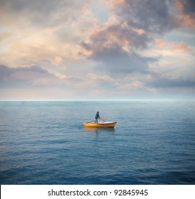 Lonely Man On A Boat In The Middle Of The Sea