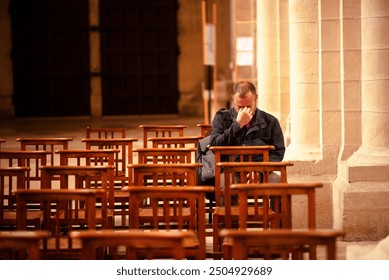 Lonely Man Sitting in an Empty Church Pew Reflecting in a Historic Church Interior. - Powered by Shutterstock