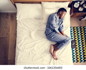 Lonely man sleeping alone on the bed