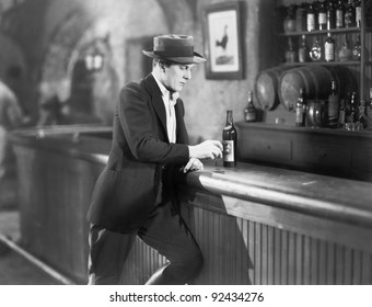 Lonely Man Standing At A Bar Counter With A Drink