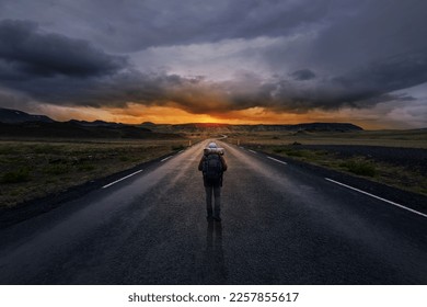 Lonely man walking down a long road - Powered by Shutterstock