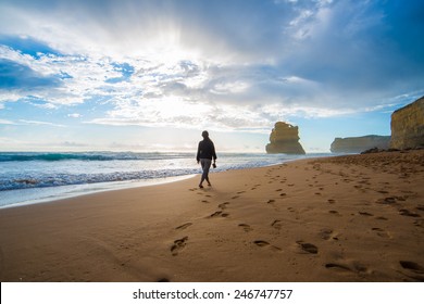 Lonely man walking on the beach leaving footprints - Shutterstock ID 246747757