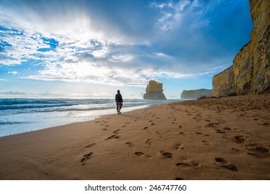 Lonely Man Walking On The Beach Leaving Footprints