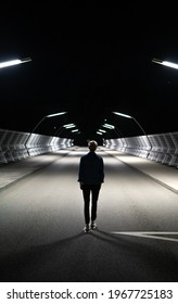 Lonely Man Walking On A Bridge At Night