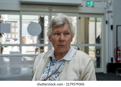 Lonely mature female senior citizen looking thoughtful, or worried in a city centre cafe. - Shutterstock ID 2179579345