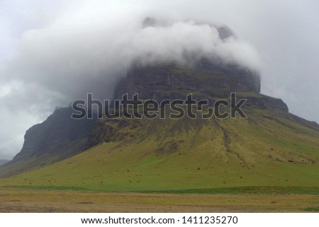 Lonely Mountain Lomagnupur with clouds - huge mountain near Kalfafell, southern Iceland