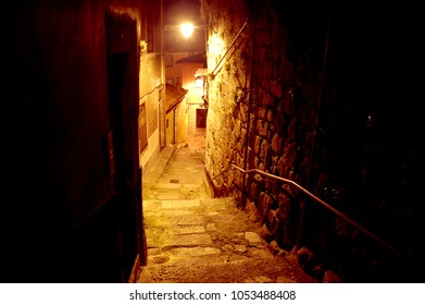 A lonely narrow street in the Porto historical old center at night - Shutterstock ID 1053488408